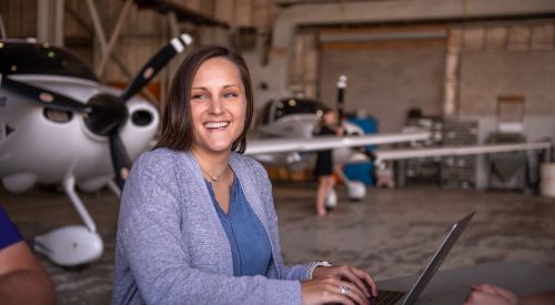 Graduate student studying in an aircraft hangar at the K-State Salina campus. 