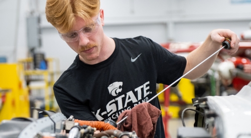 Students maintenancing an aircraft engine at the K-State Salina campus