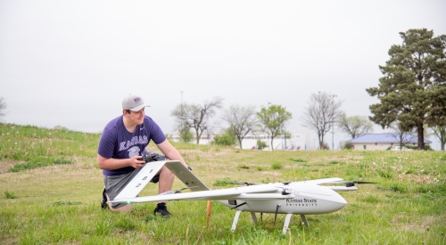 A student prepares to fly a drone near the K-State Salina campus.