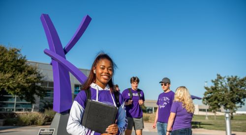 Students going to college for the first time as student converses with friends on the K-State Salina campus.