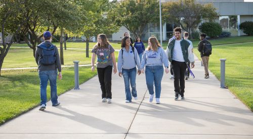 Returning to K-State Salina after a semester away as students converse with each other on campus. 