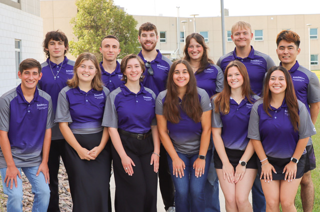 The 12 K-State Salina resident assistants in a group photo while all smiling.