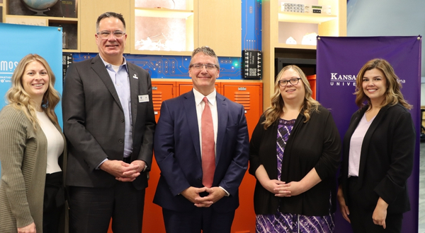 K-State Salina representatives stand smiling with Cosmosphere representatives during the official announcement of their partnership.