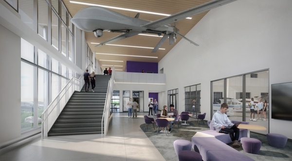 Rendering of the interior lobby of the Aerospace Education Hub at K-State Salina with lots of space to sit, tall stairs with big windows and a large drone hang from the ceiling.