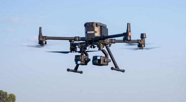 A DJI M300 UAS that is offered at K-State Salina flies in the air with a clear blue sky backdrop. 