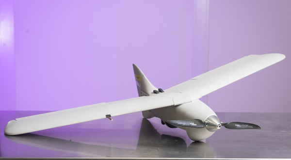 UTC Aerospace Vireo drone that is gray in color with a purple light backdrop at the K-State Salina campus. 