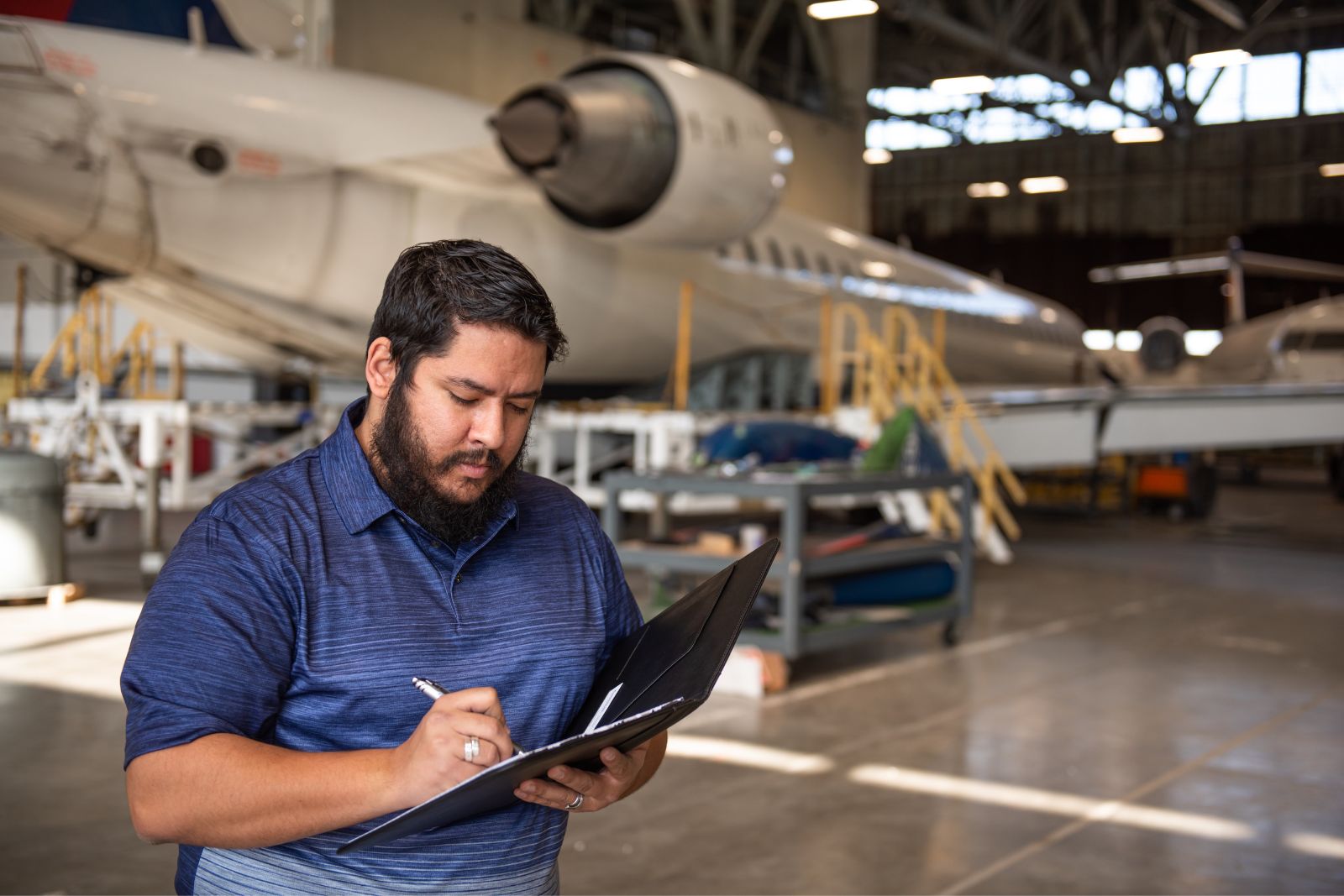 A professional learner inspecting aircraft at the K-State Salina campus