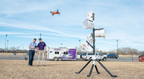 A learner flies a drone into buckets set up in order to train new drone operators as a K-State Salina UAS instructor closely watches. 