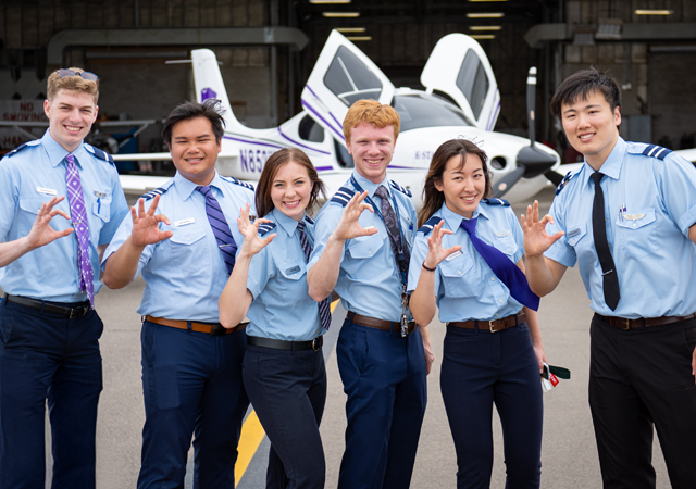 Group of professional pilot students posing for the camera